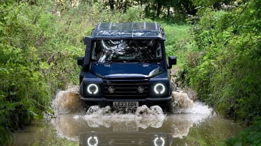 Ineos Grenadier driving through a ford